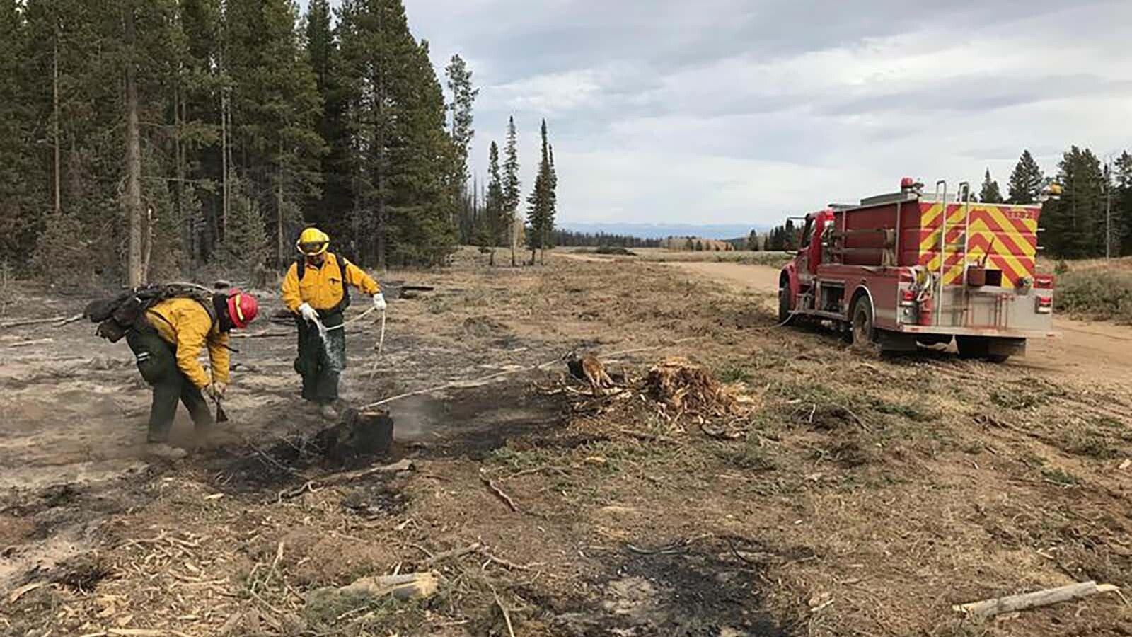 Fire crews put out a hot spot in the Roosevelt Fire in Wyoming in 2018, which burned more than 65,000 acres and 55 homes.