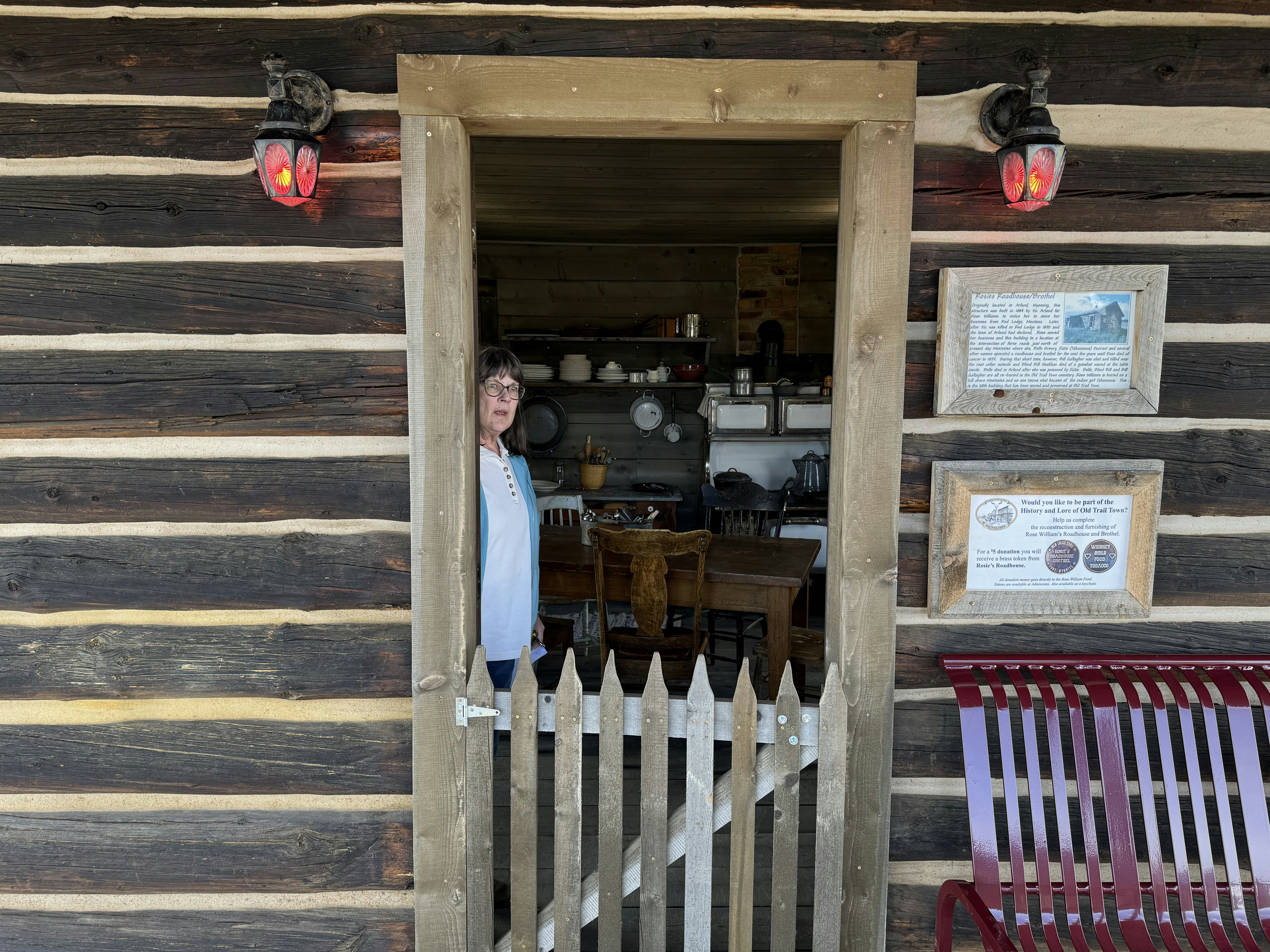 Sylvia Huber, Old Trail Town's collections manager, stands in the doorway of Rose Williams' Roadhouse and Brothel at Old Trail Town in Cody.
