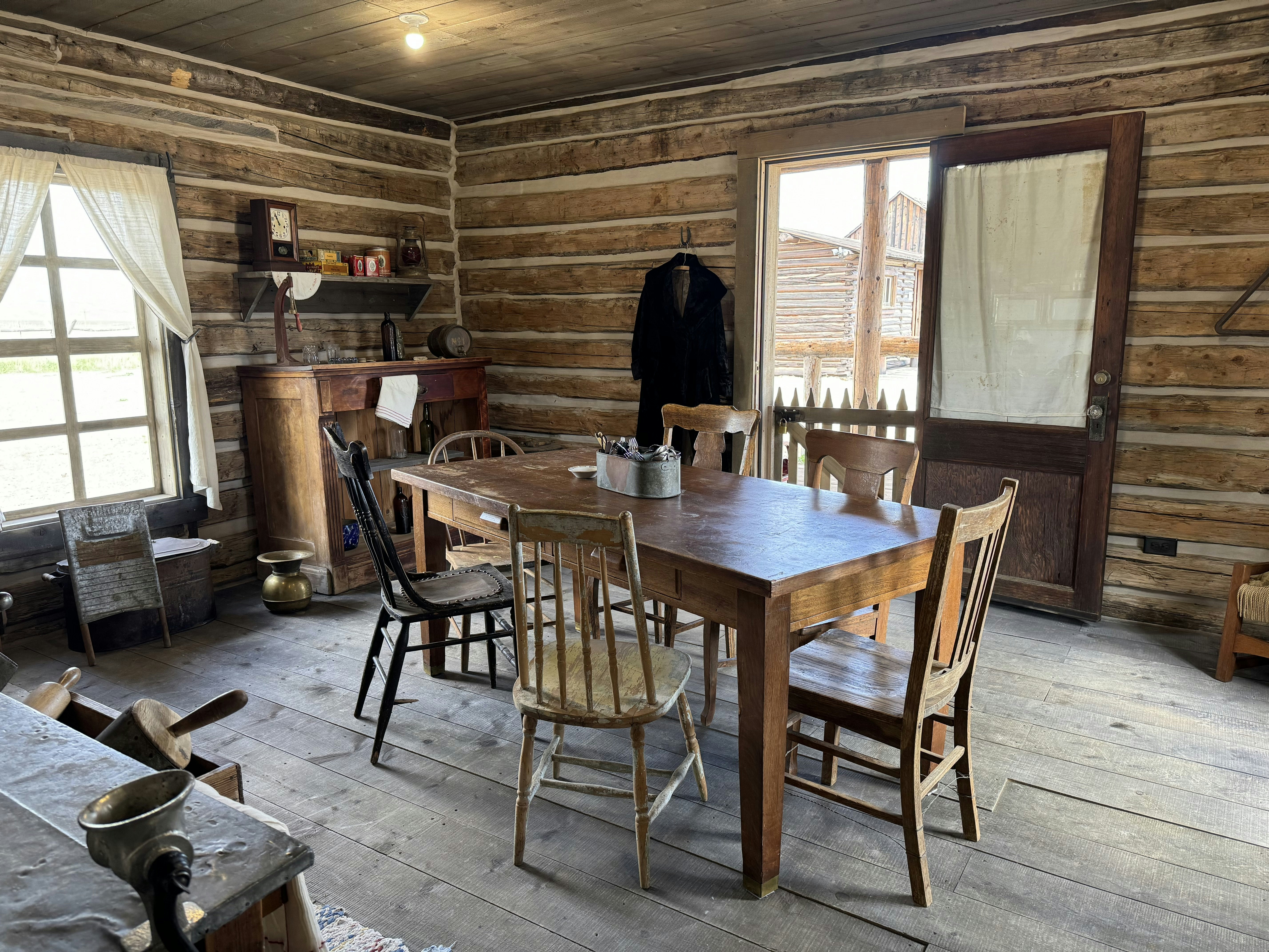 The front room of Rose Williams' Roadhouse and Brothel, with a kitchen table and a small bar in the corner. "Blind Bill" Hoolihan was sitting at the end of this table when he was shot from behind by someone standing in the doorway where this picture was taken.