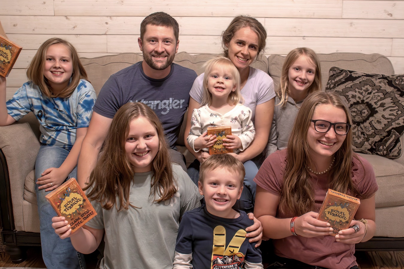 Mark McKenna and his family created the card game Royal Turmoil, which is for sale on Amazon. The McKennas are, from left, front, Lexi, Grant and Jamie; back, Macie, Mark, Hailey, Sheena and Natalie.