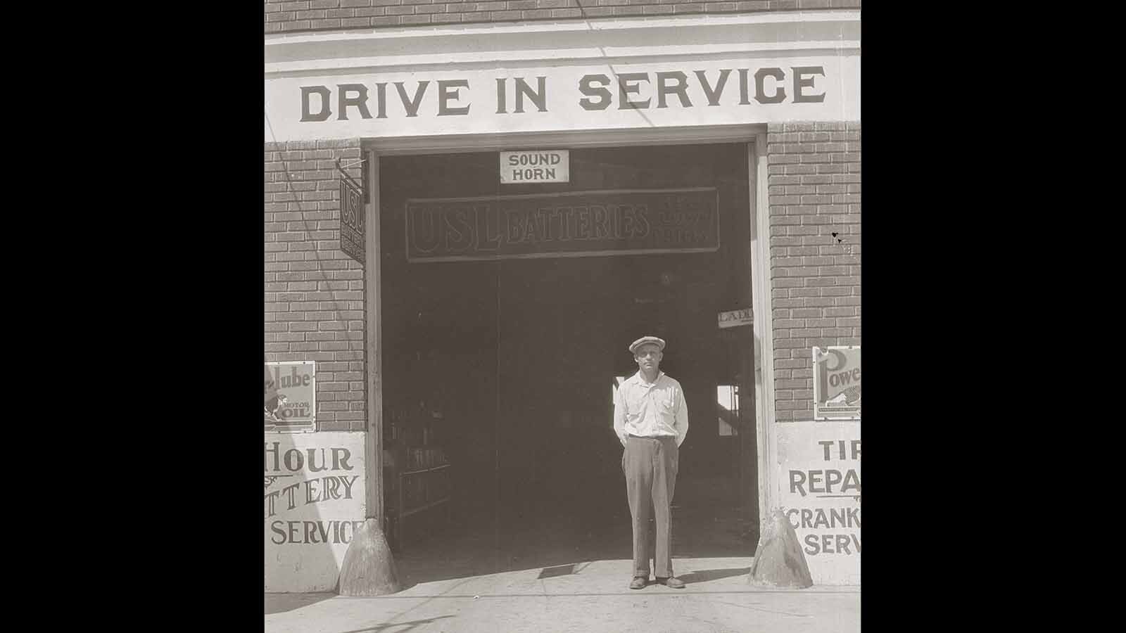 Joe Carey standing in the door of his garage in the 1920s