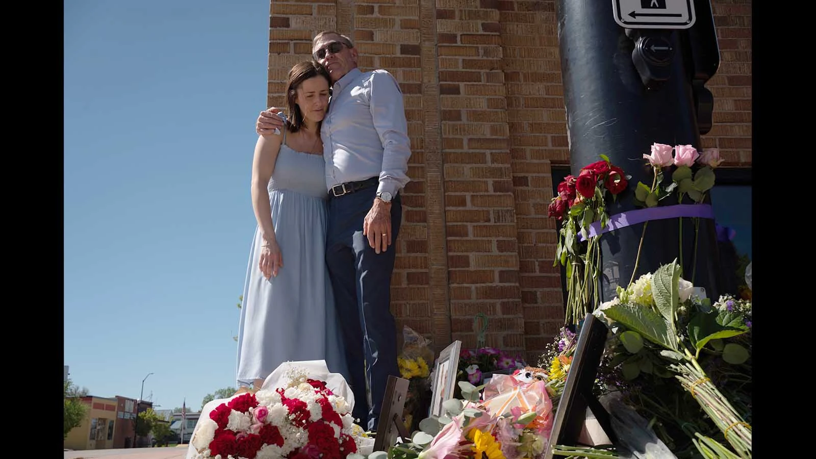 Kate Gladdin and her father share a moment at a memorial for the death of her mother, who was run down by a distracted motorist in downtown Sheridan.