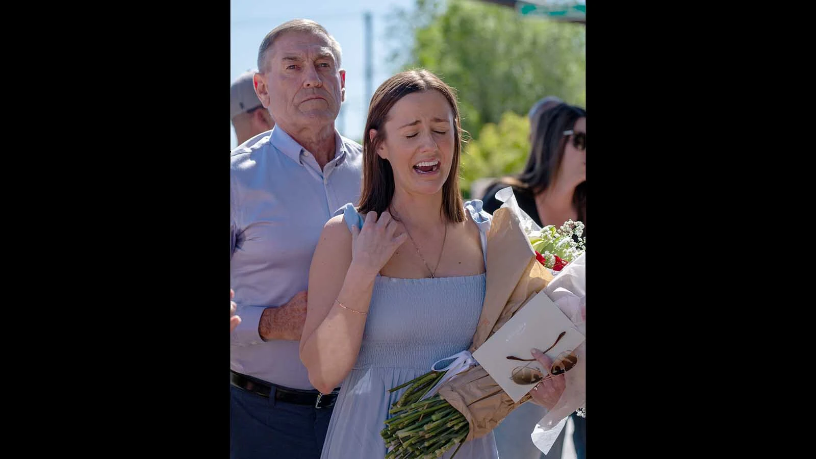 Kate Gladdin cries during a memorial for her mother.