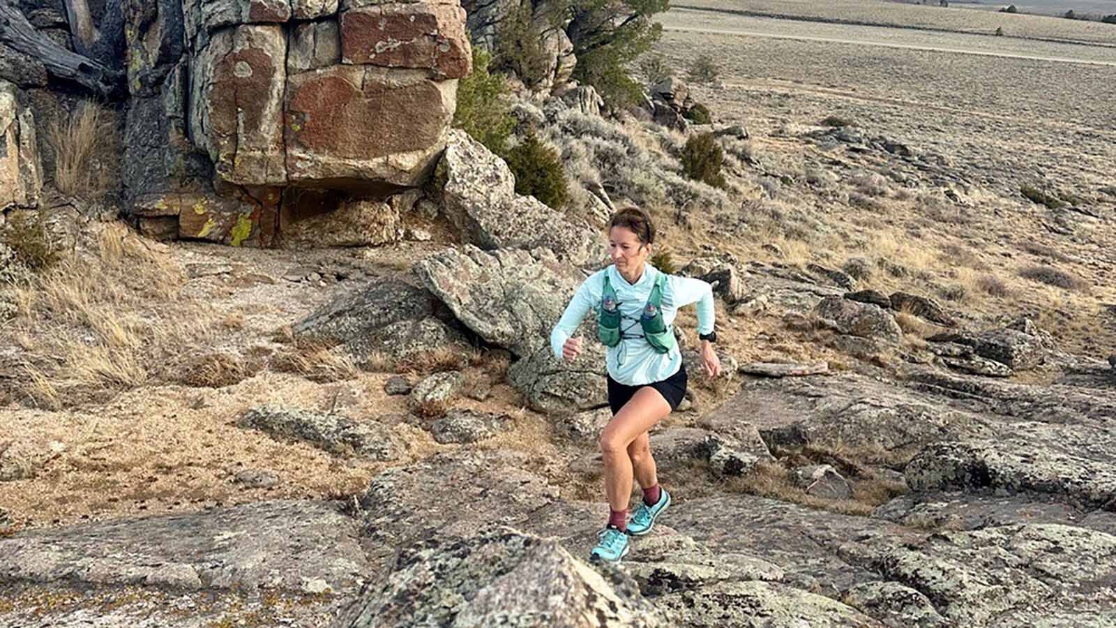 A lone runner passes an outcropping of rocks during the 2024 Run the Red trail run.