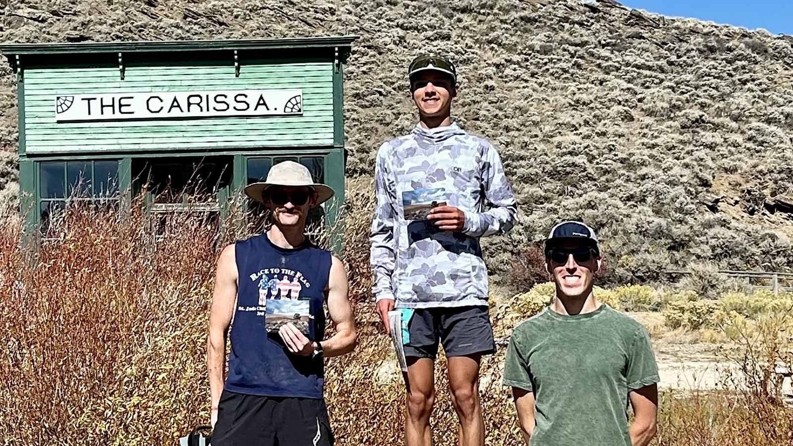 Last year's Run the Red Desert 50K winner Diego Lobatos stands atop a makeshift podium, along with Nicholas Dea, left, and Chris Smallwood.