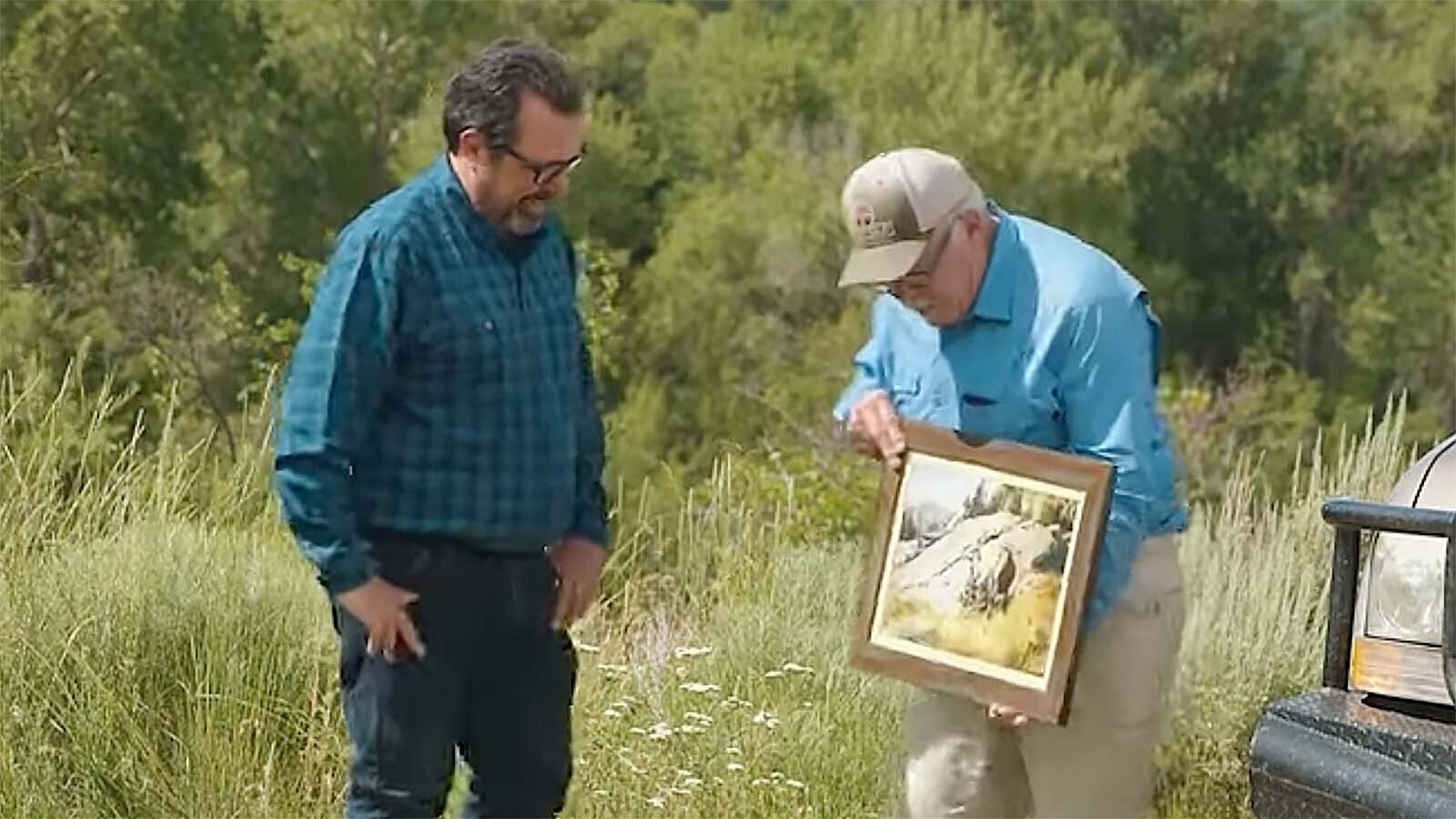 Russell Nelson shows Adam Harris his print of “The Last of the Velvet” in a National Museum of Wildlife Art YouTube video about Carl Rungius.