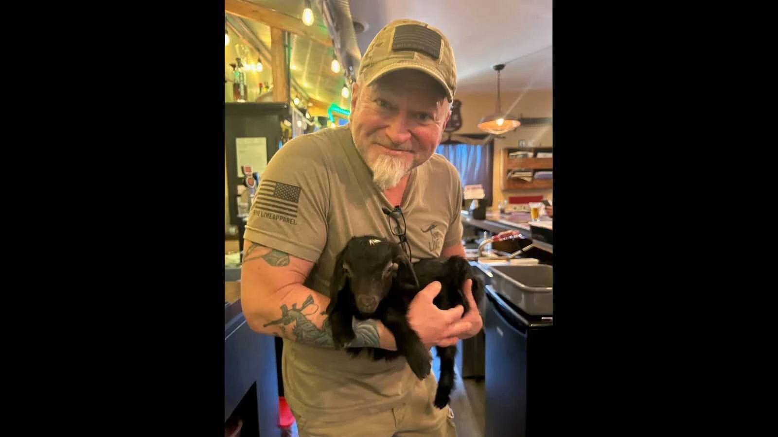 Bombshells American Cuisine staff take turns cuddling Tenacity and posing for photos.