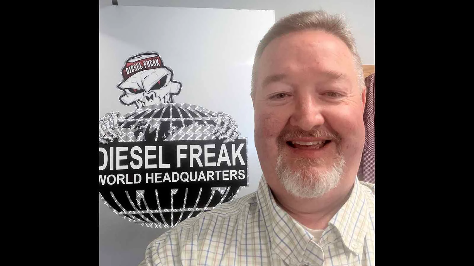 Ryan LaLone poses in front of his Diesel Freak shop sign. Until President Trump pardoned him Friday, he was a convicted felon for deleting emissions systems from ailing trucks.