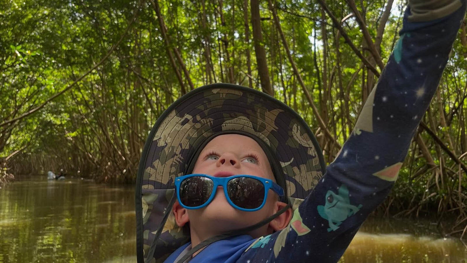 Aksel Schell, 5, takes a selfie during a trip to explore a mangrove-lined river.