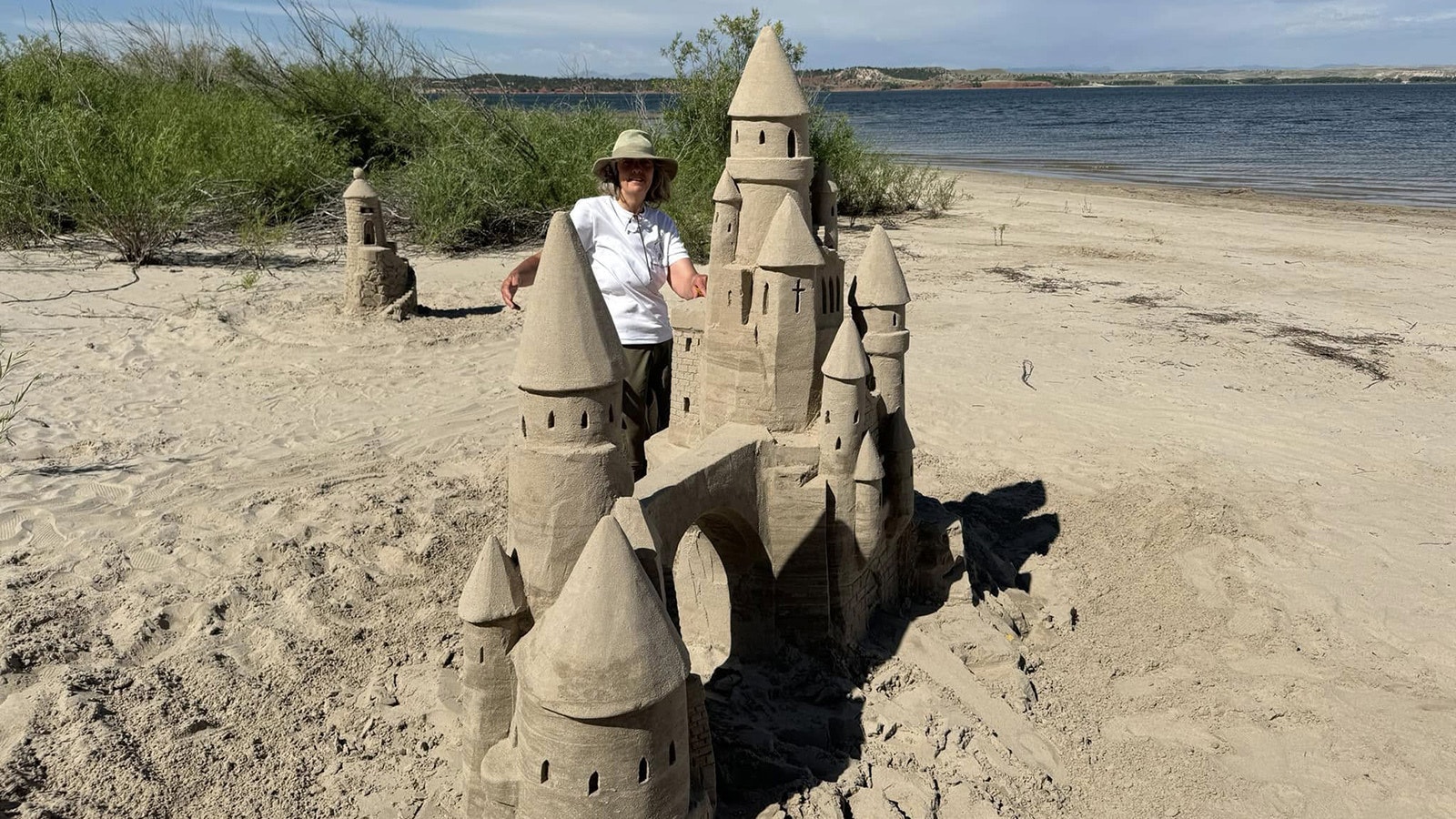 Catherine Johnson Morris poses with a sandcastle at Glendo State Park.