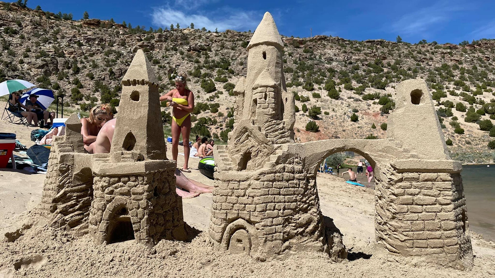 People often gather to watch Morris when she's buliding sandcastles. That leads to some impromptu beach lessons on sand sculpting with children, who just can't resist, not even for their cellphones.