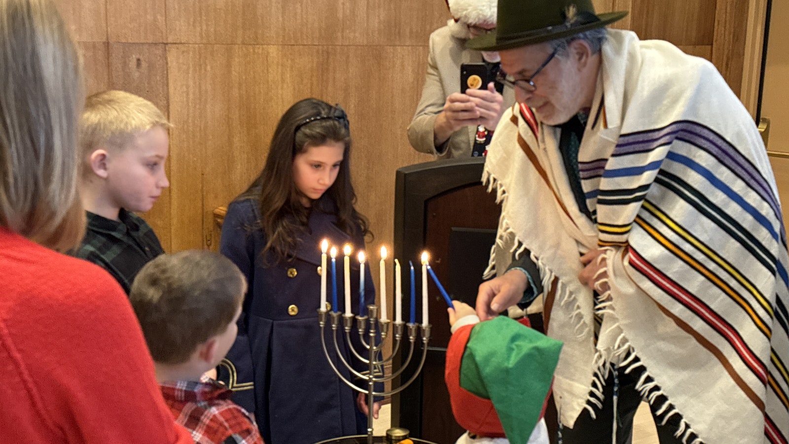 Rabbi Edward Stafman guides children lighting a Hannukah menorah during the Dec. 15 Christmas tree lighting at Mammoth Hot Springs.