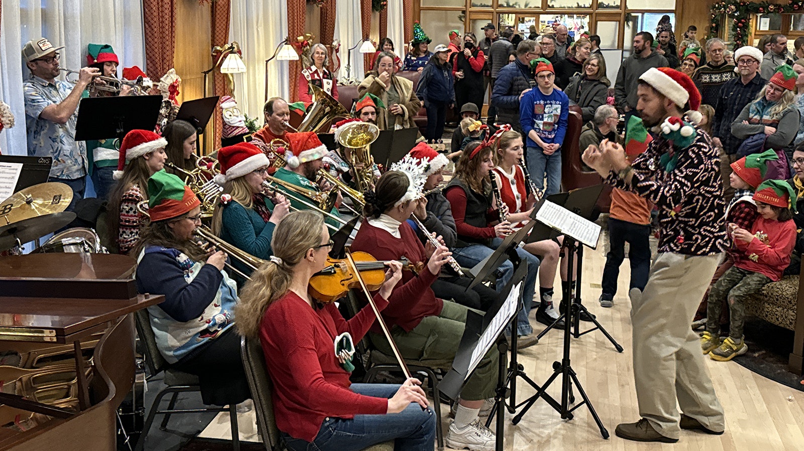 The Gardiner Community Band performs Christmas carols in the Map Room of Mammoth Hot Springs Hotel.