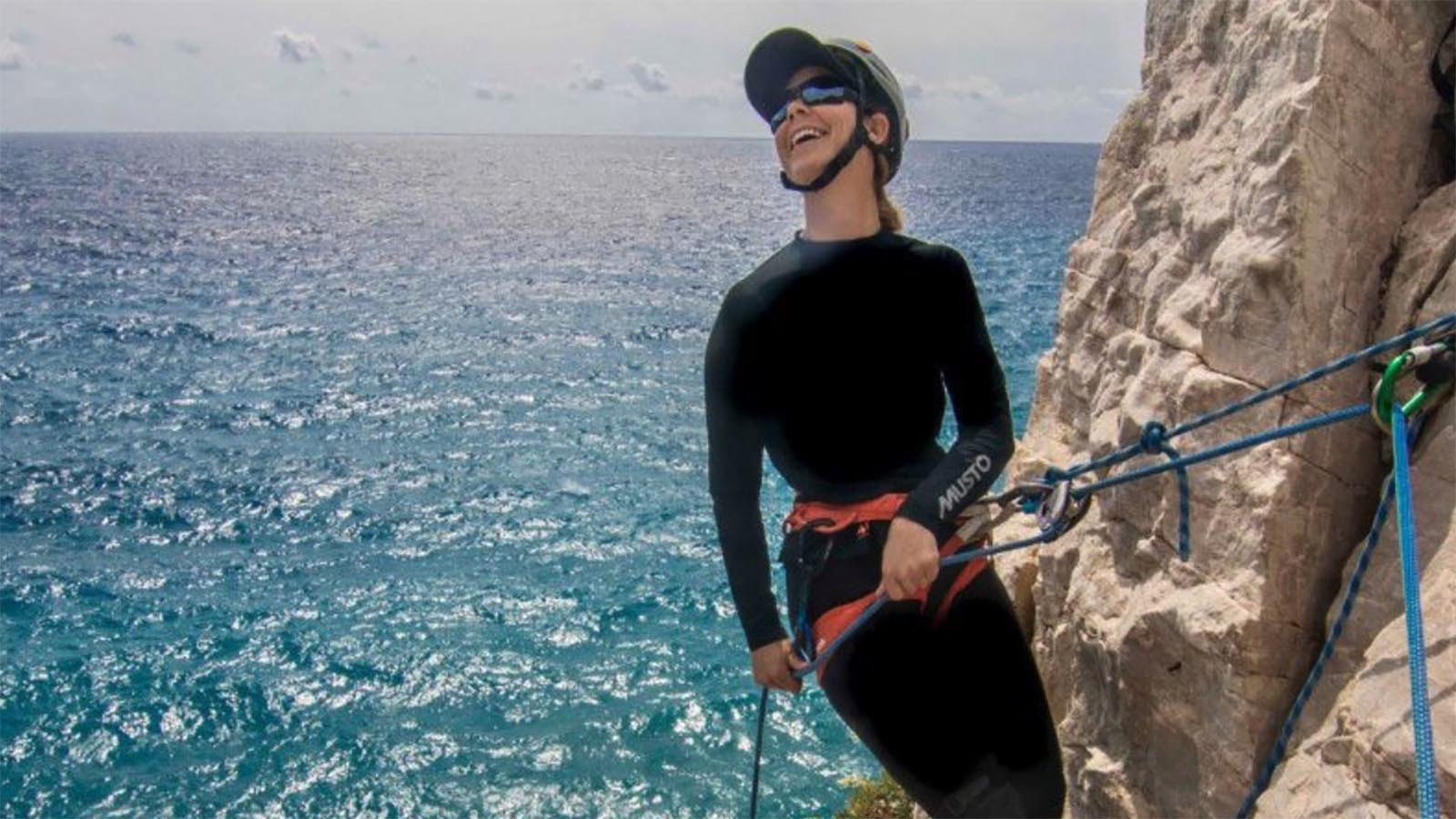 Climbing on cliffs over the ocean in Italy.