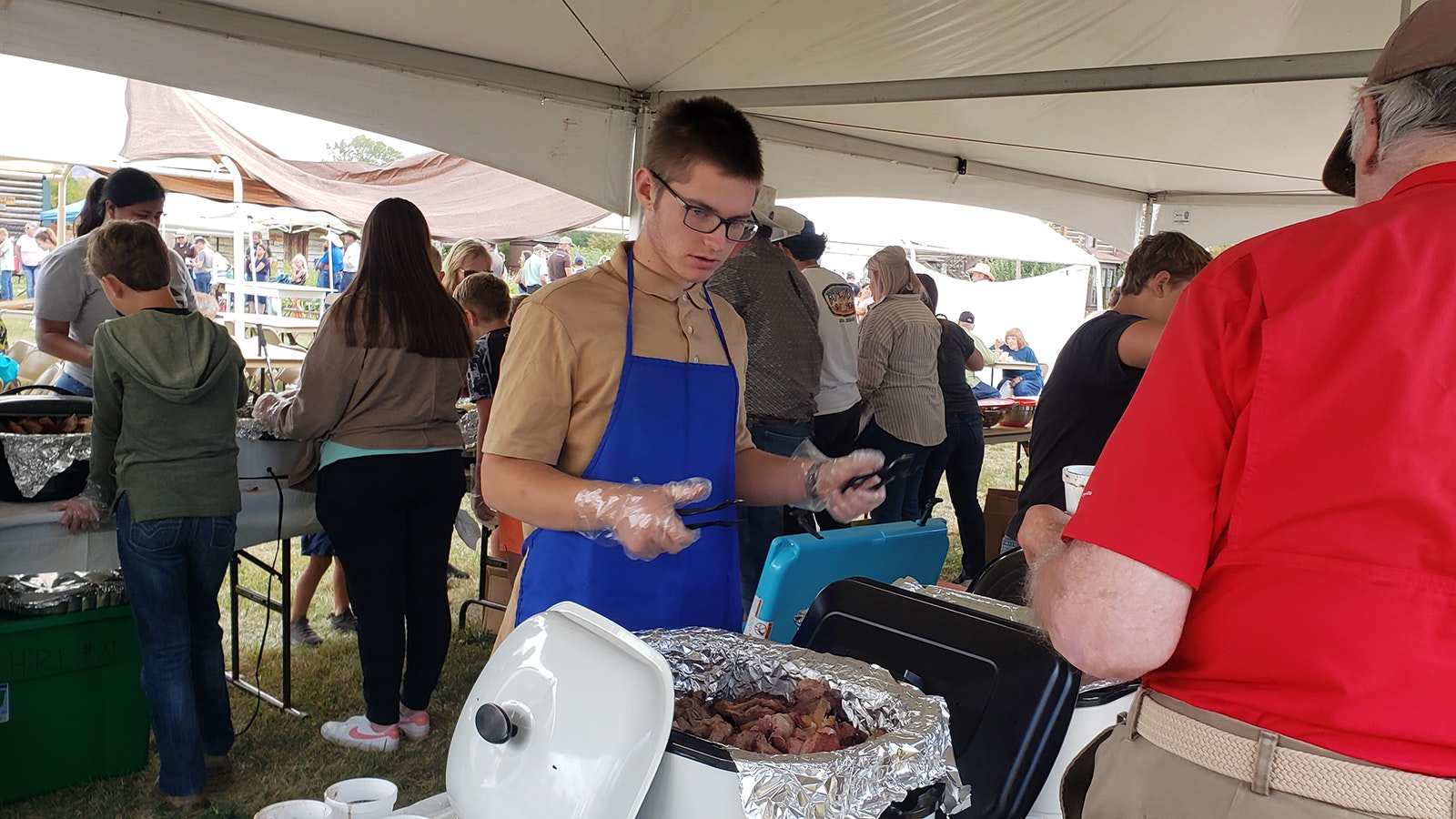 FFA students volunteered to help serve the meat and potluck sides at the Savery picnic.