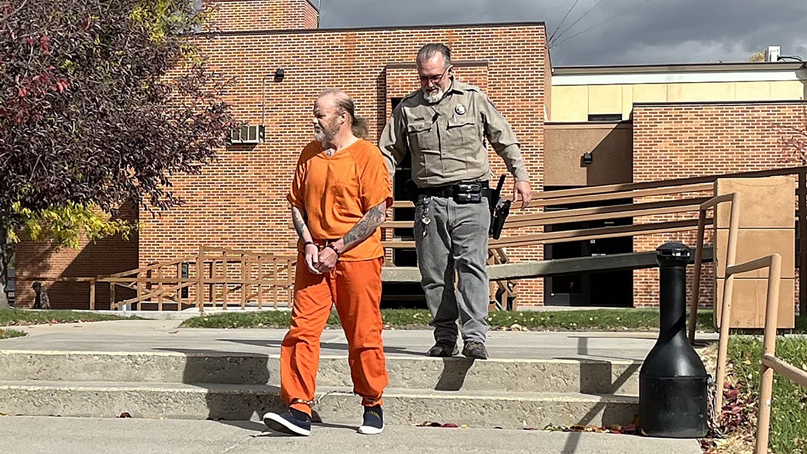 Sean Brennan walks to a Fremont County jail transport van Thursday, Oct. 17, 2024, after pleading not guilty to a child sex charge in Lander