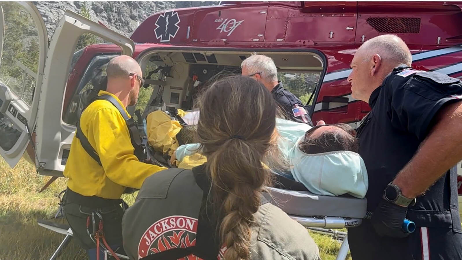 Era Aranow, a member of the Fremont County Search and Rescue Lander Unit, is helped by her fellow responders after being hurt on a mission.