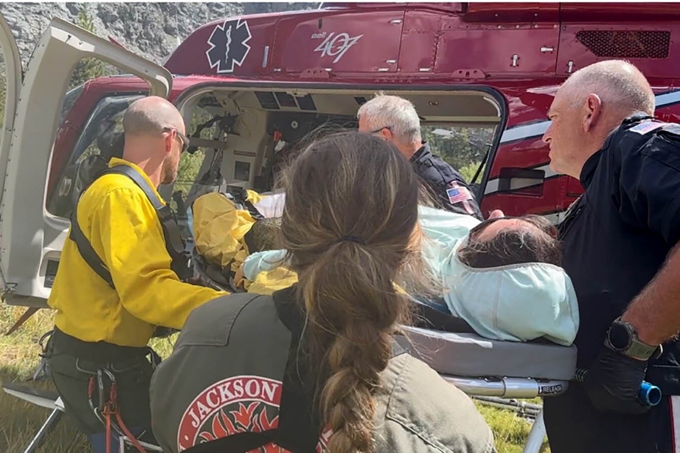 Era Aranow, a member of the Fremont County Search and Rescue Lander Unit, is helped by her fellow responders after being hurt on a mission.