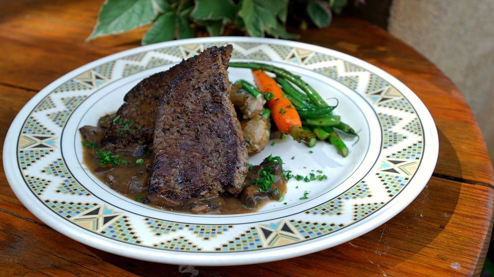 Seared proghorn steaks with potatoes, carrot and green beans.