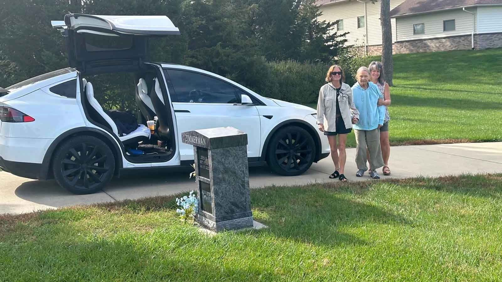 Nancy Sniffin is helped by her two daughters at the cemetery in Harlan, Iowa.