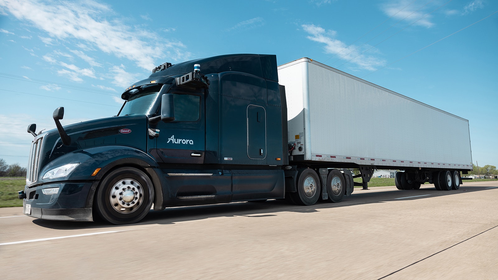 A truck equipped with self-driving technology on the road.