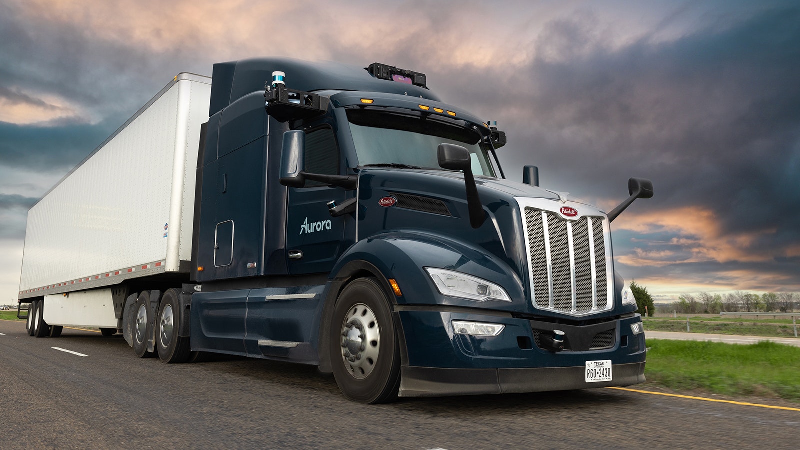 A truck equipped with self-driving technology on the road.