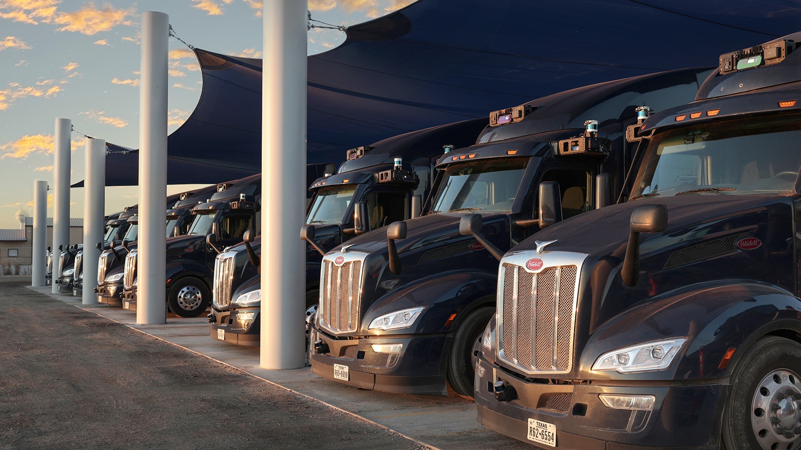 A feet of semitrucks equipped with Aurora self-driving technology.