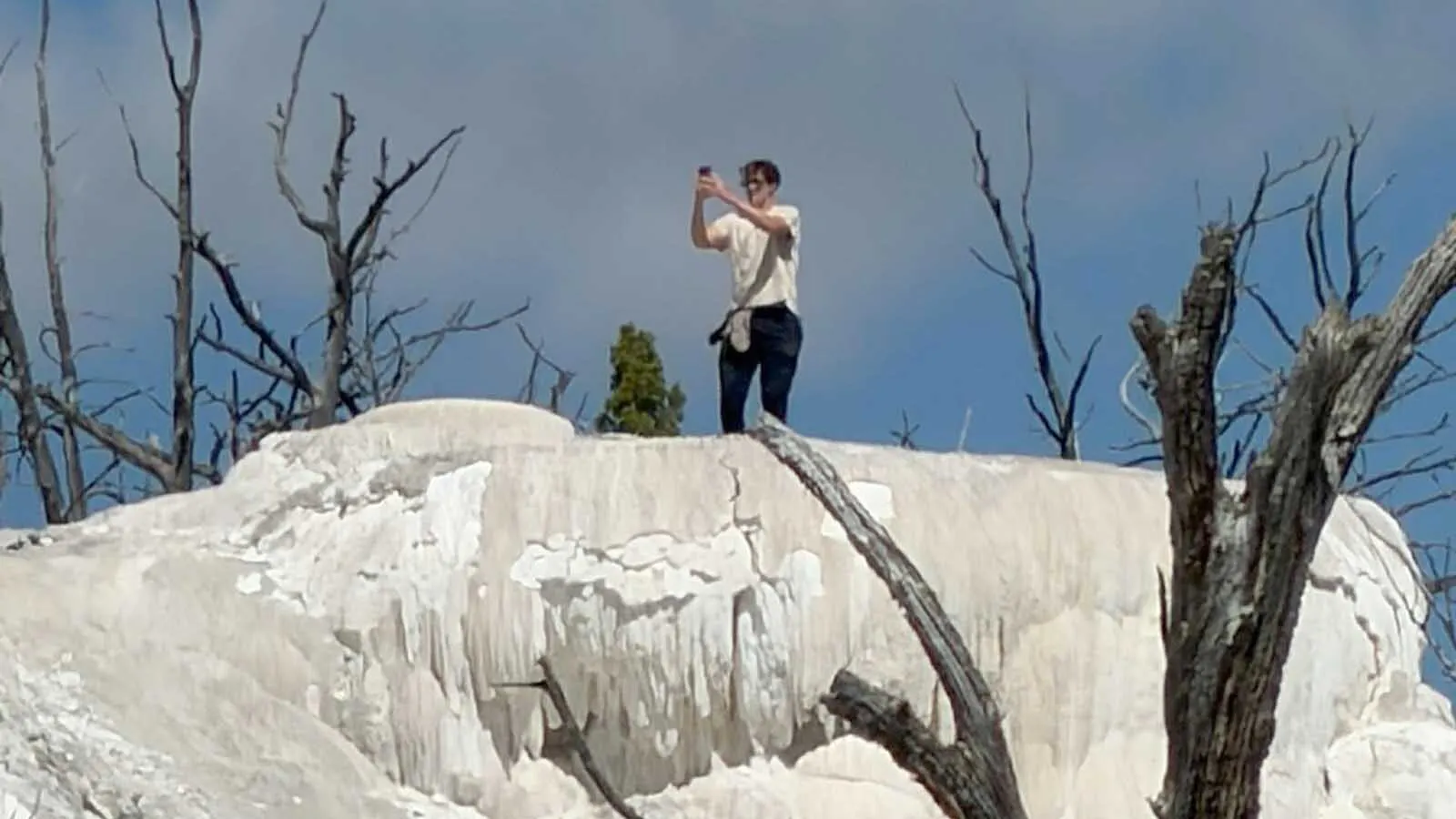 Dane Eyerly was visiting Yellowstone National Park when he got this photo of another visitor illegally on a thermal feature taking selfies. "Don't be this guy," Eyerly advised in sharing the photos to the Yellowstone and Grand Teton National Park Facebook group.