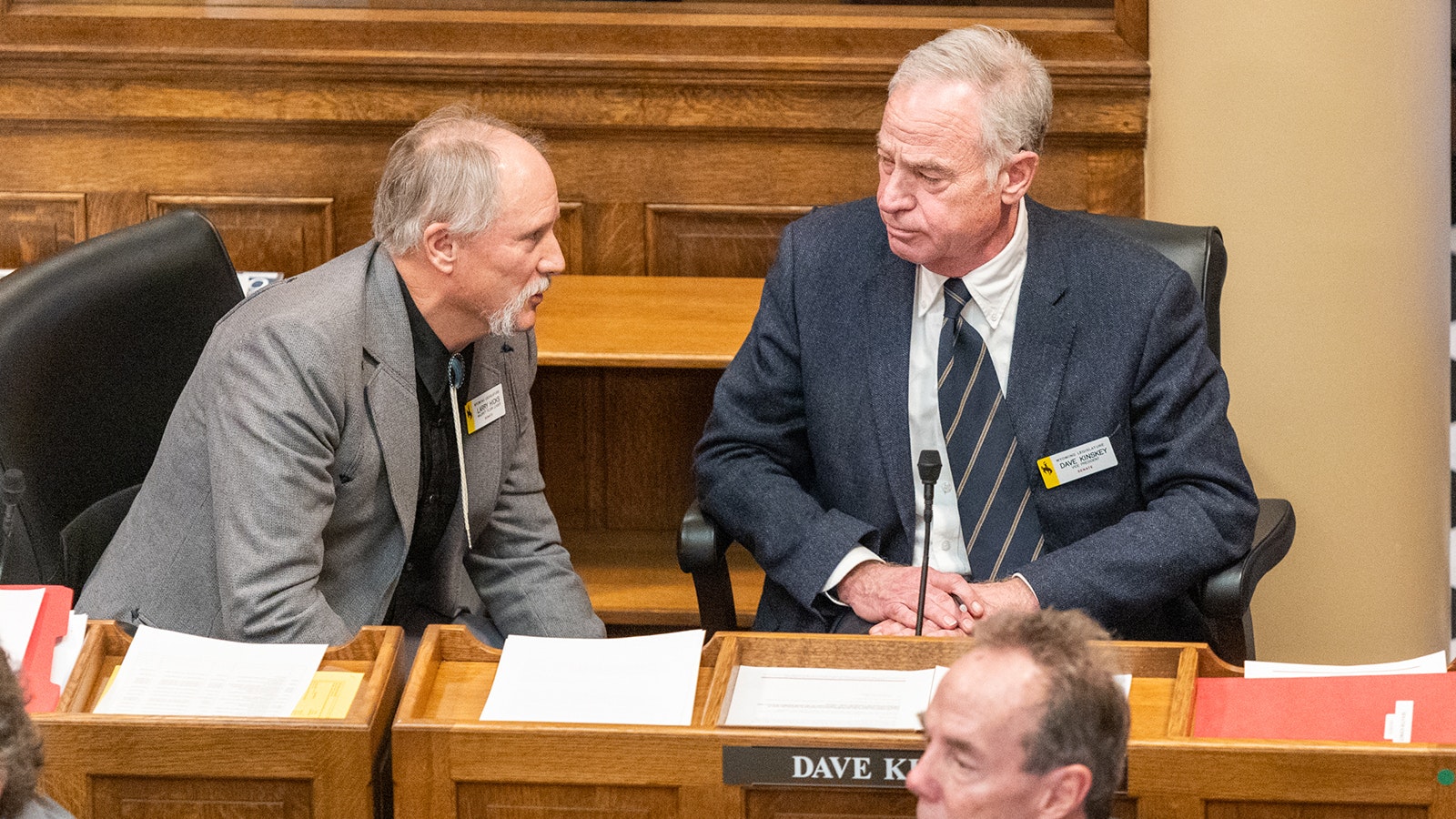 Sens. Larry Hicks and Dave Kinsey talk during the first day of the 2024 legislative session. The first order of business for the Senate was overturning a decision by Senate President Ogden Driskill in the interim to remove Kinskey as chairman of the Appropriations Committee.