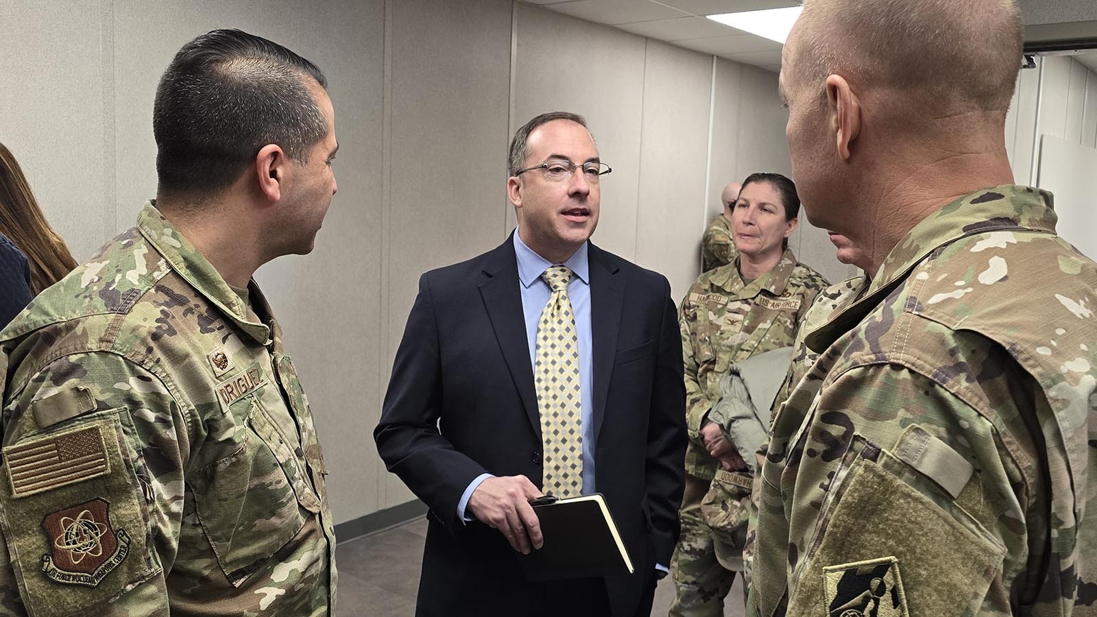 Director of Air Force Global Strike Command, Detachment 10, Site Activation Task Force, Steve Kravitsky, center, speaks with other military officials after a ceremony to celebrate the opening of the Site Activation Task Force headquarters on Wednesday.