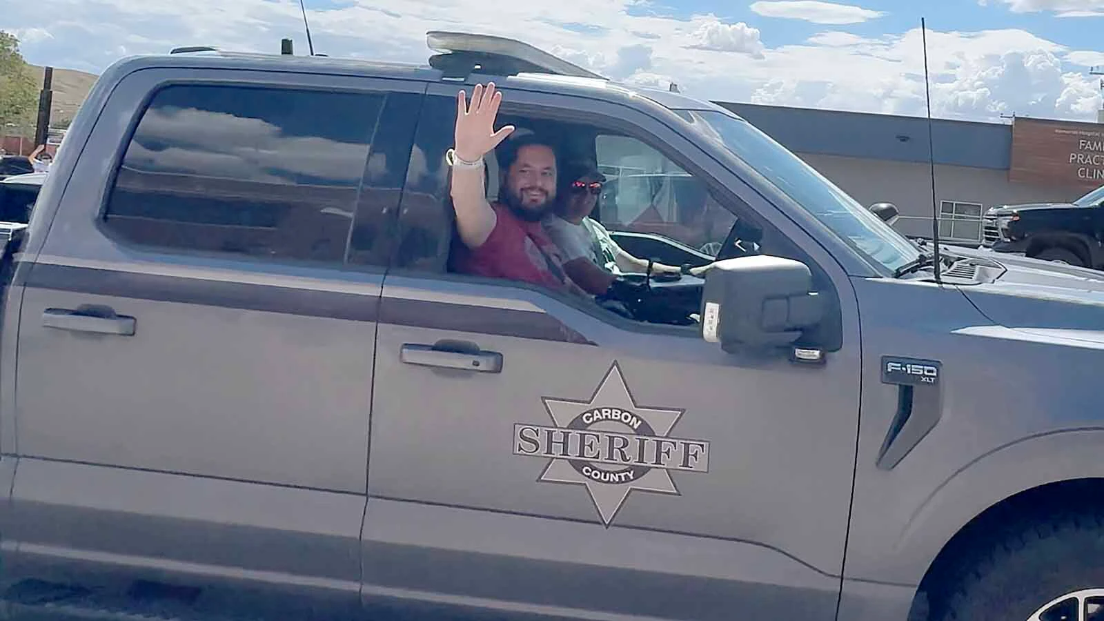 Sgt. Zach Burns waves to people in Rawlins who turned out Wednesday to welcoming him home about six weeks after he was shot three times by a gunman in Baggs, Wyoming.