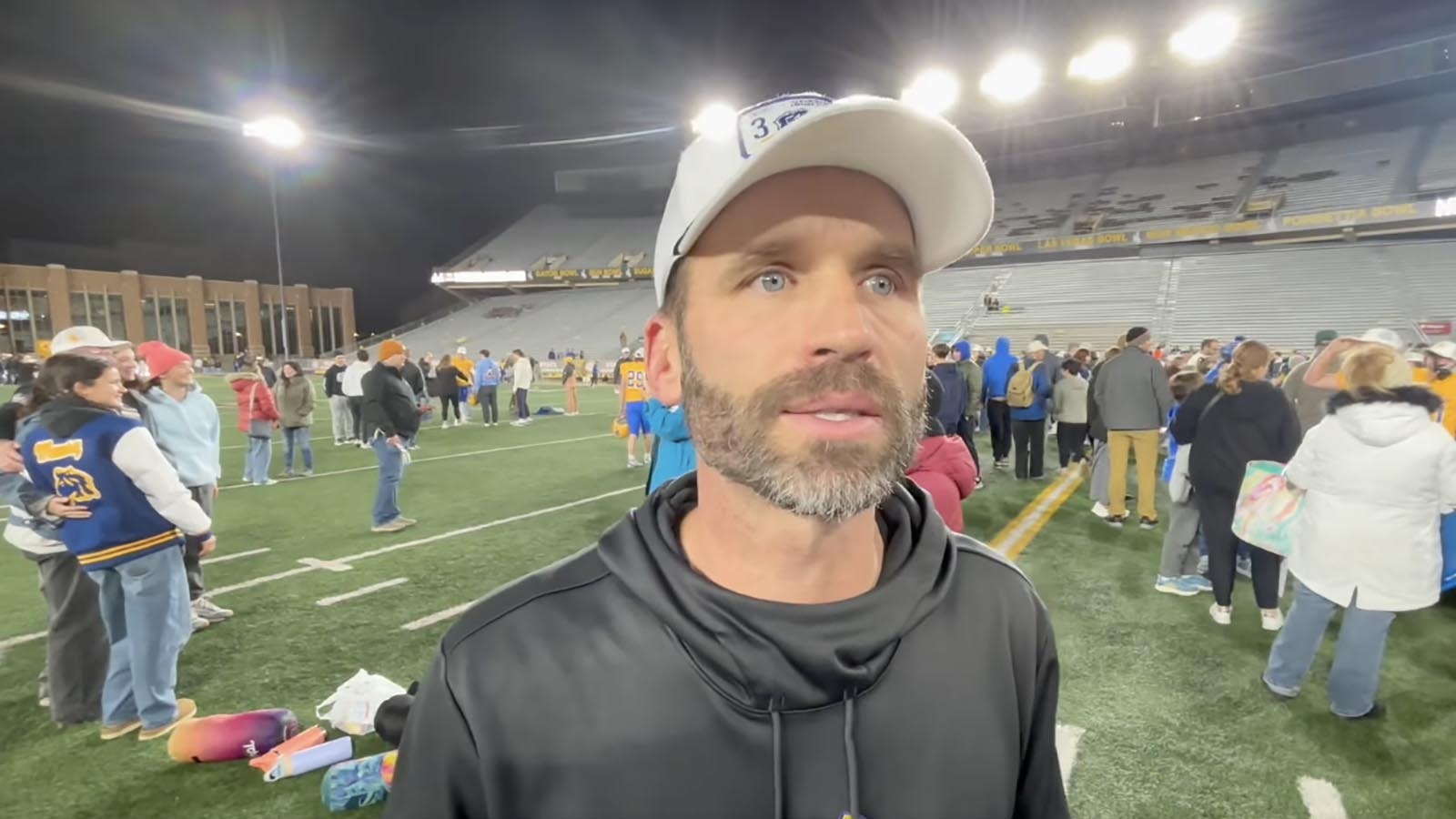 This year’s undefeated football championship run by the Sheridan Broncs was business as usual since former Head Coach Don Julian started a winning tradition current Head Coach Jeff Mowr, above, continues. The secret to their success? Building leadership skills during retreats in the woods. A program describing the retreats includes photos of trust exercises and the team circled up for prayer.