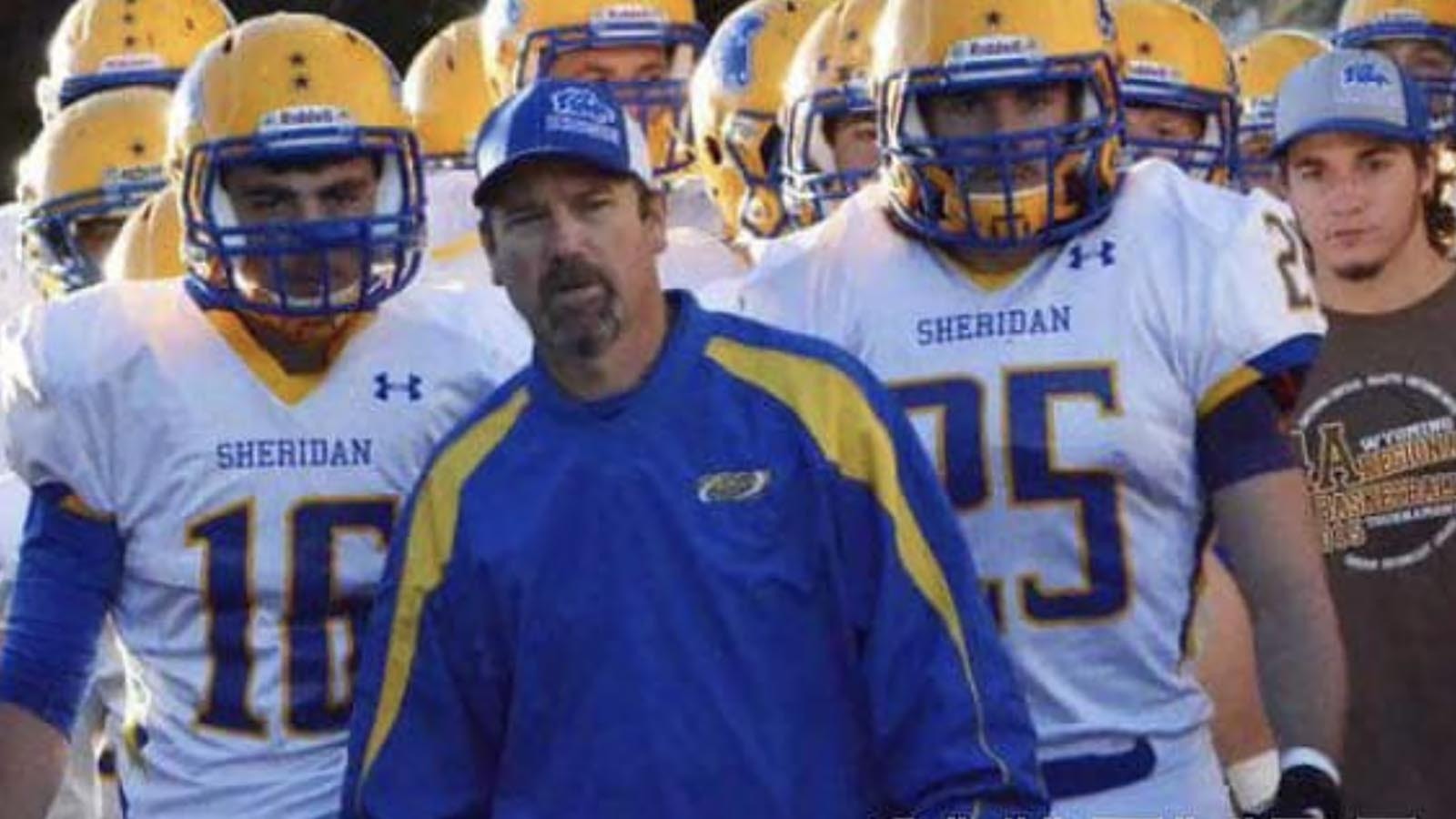 This year’s undefeated football championship run by the Sheridan Broncs was business as usual since former Head Coach Don Julian, above, started a winning tradition current Head Coach Jeff Mowry continues. The secret to their success? Building leadership skills during retreats in the woods. A program describing the retreats includes photos of trust exercises and the team circled up for prayer.