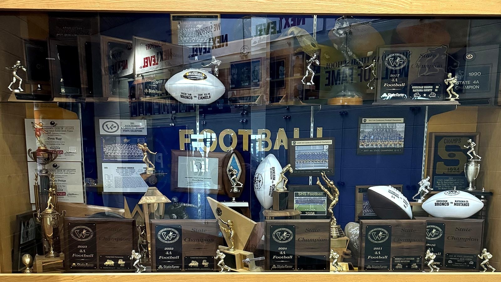 The Sheridan High School trophy case is full of championship trophies won by the football team.