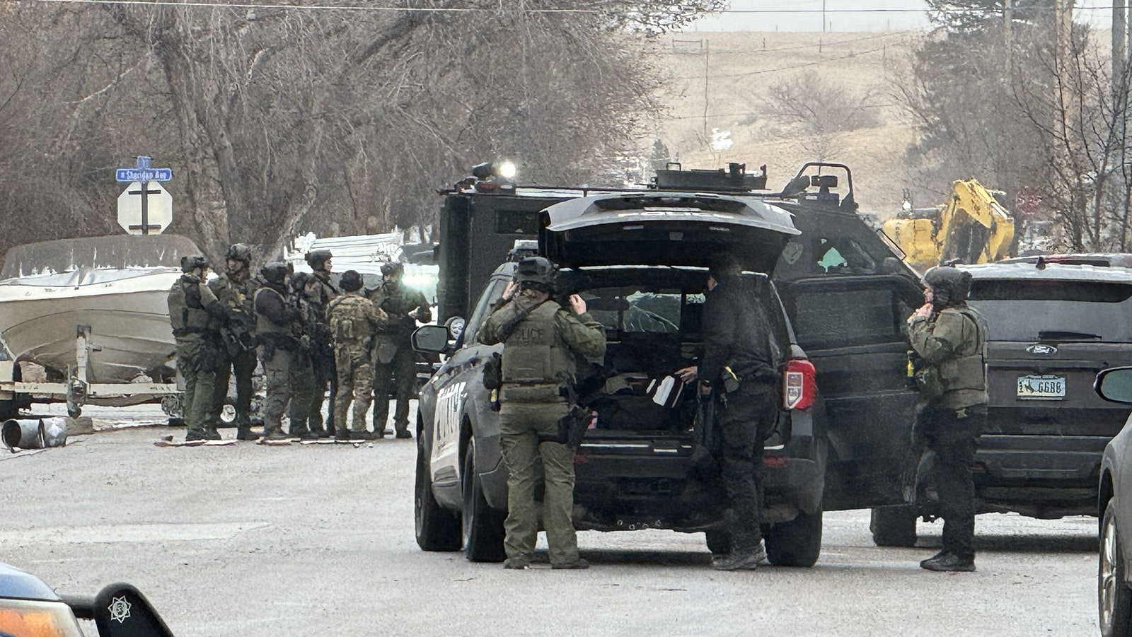 Scenes Wednesday morning from a standoff in Sheridan between law enforcement and a man suspected of shooting and killing a police officer.