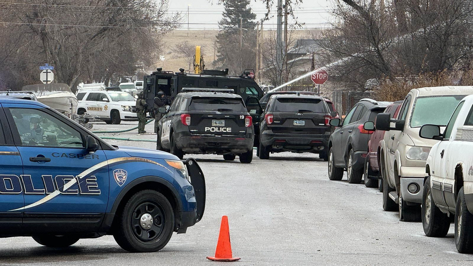 Scenes Wednesday morning from a standoff in Sheridan between law enforcement and a man suspected of shooting and killing a police officer.