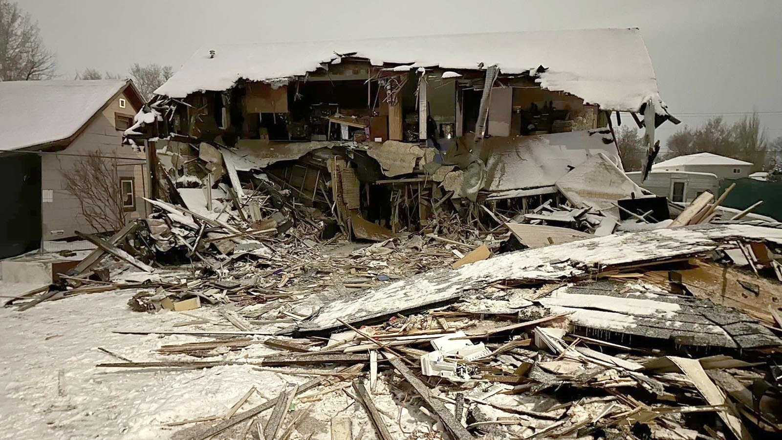 After a 32-hour standoff between law enforcement and a man suspected of killing a local police officer, the Sheridan home he barricaded himself in shows the extensive damage done to it during attempts to get to the suspect.