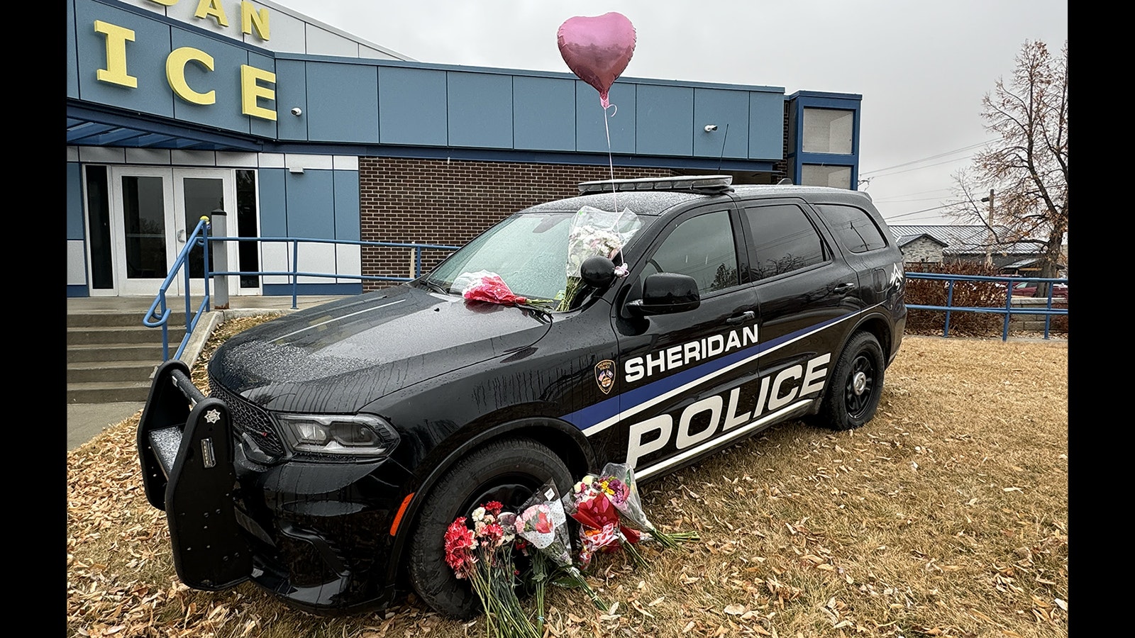 Sgt. Nevada Krinkee's Sheridan Police Department cruiser is parked in front of the police station for people to leave memorials to the six-year officer who was killed in the line of duty Tuesday, Feb. 13, 2024.