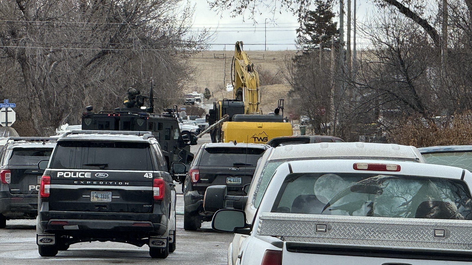 Scenes Wednesday from a standoff in Sheridan between law enforcement and a man suspected of shooting and killing a police officer.