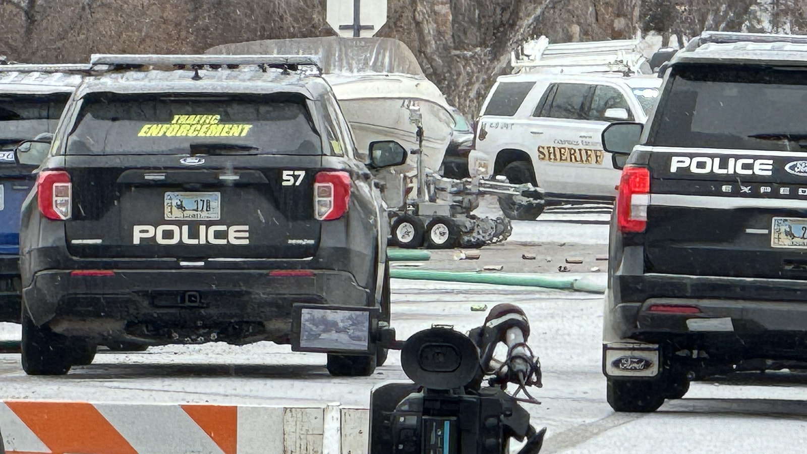 A tactical robot is deployed toward a house where a man is in a standoff with Sheridan police