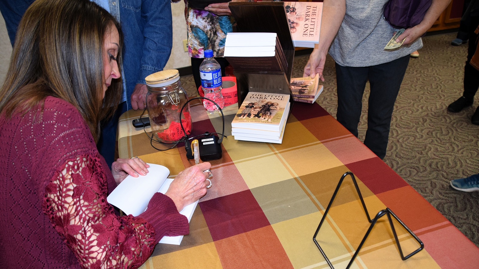 Shirley Munoz Newson signs copies of her book, "The Little Dark One: A True Story of Switched at Birth," at the Campbell County Public Library in her hometown of Gillette, Wyoming.