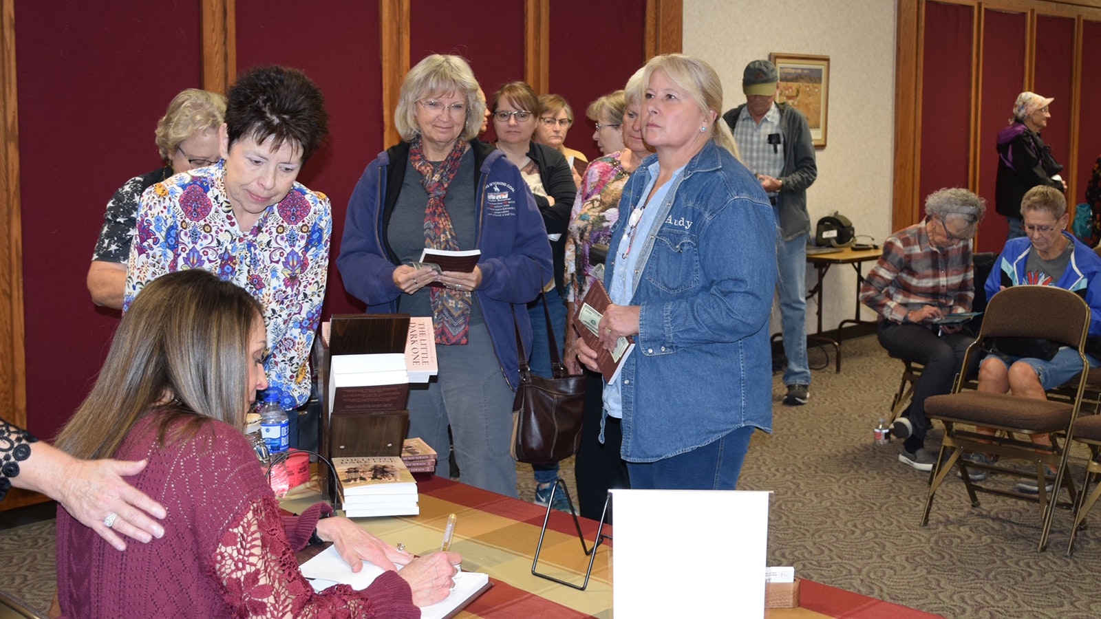 Shirley Munoz Newson signs copies of her book, "The Little Dark One: A True Story of Switched at Birth," at the Campbell County Public Library in Gillette, Wyoming.