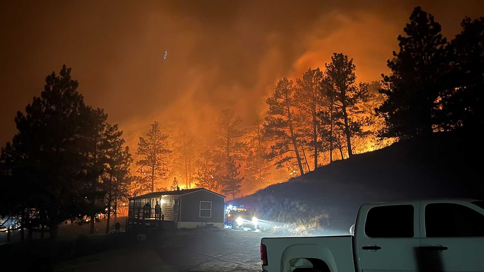 Yoder Volunteer Fire Department Brush Truck 31 saved this home on the overnight shift Thursday night and Friday morning fighting the Short Draw Fire near Recluse, Wyoming. The truck is crewed by Caleb Anderson and Abigail Anderson — a brother/sister firefighting team — and Witman Jones.