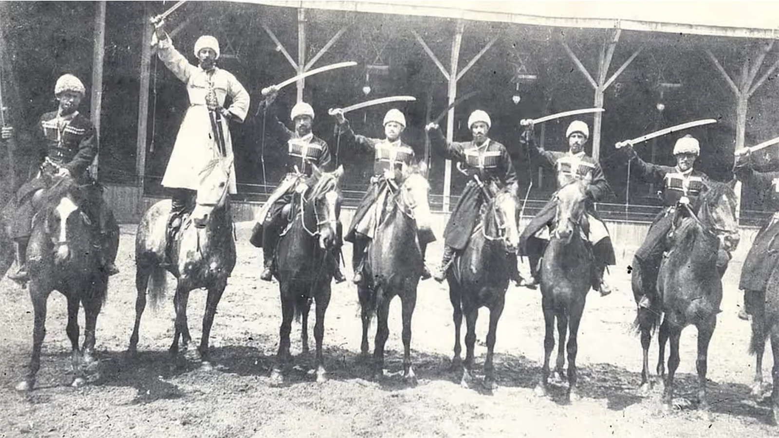 Glenn Kischko was the son of a Prince Luka, a Georgian horsemen who performed with Buffalo Bill’s Wild West Show. It is most likely his last name was Americanized. His father is pictured standing on the horse, in white chokha, and called Luka Chkhartishvili in the photo caption.