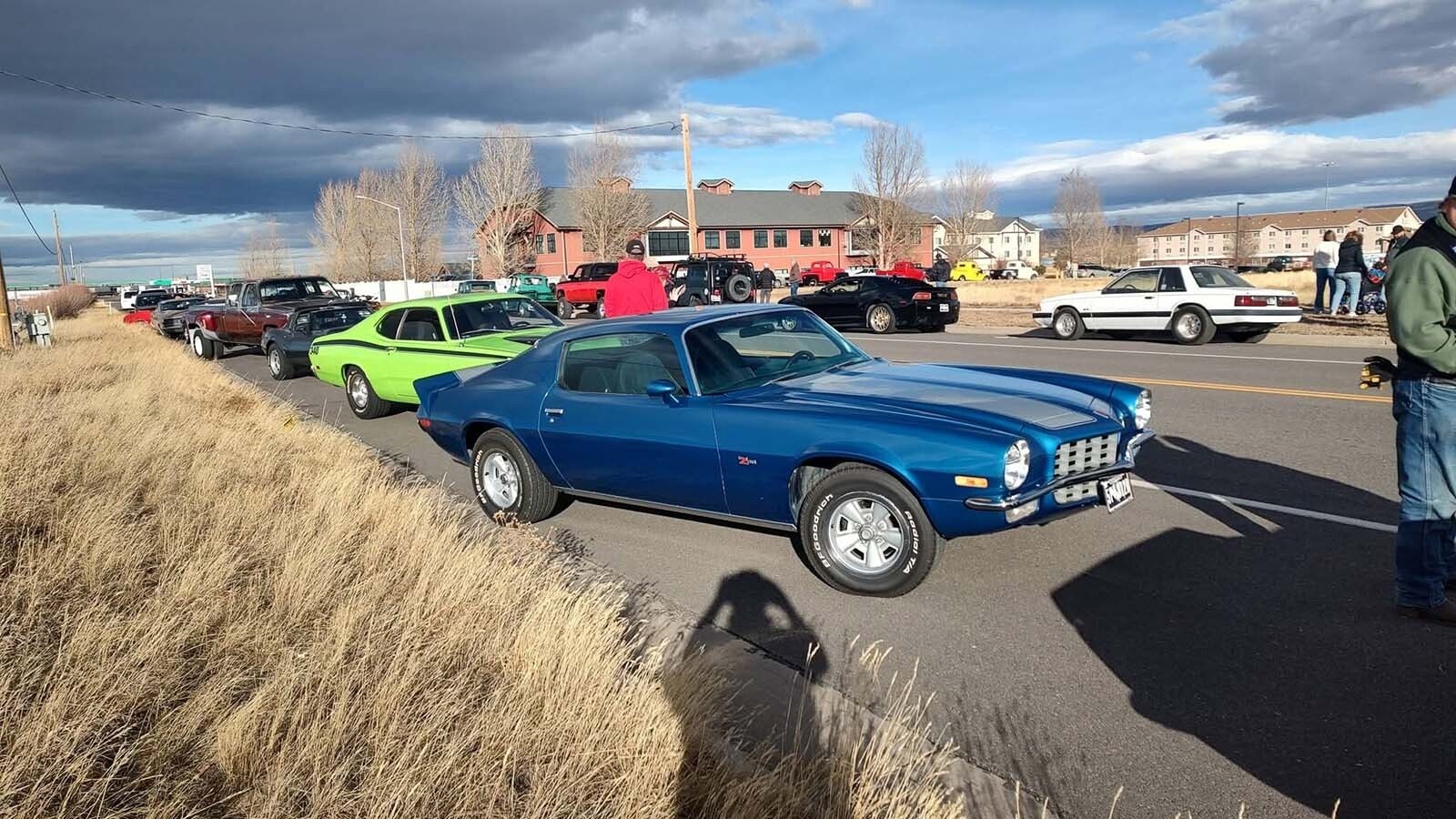 Vehicles are parked all along Pierce Street and Centennial Drive as part of the car show for a young cancer patient