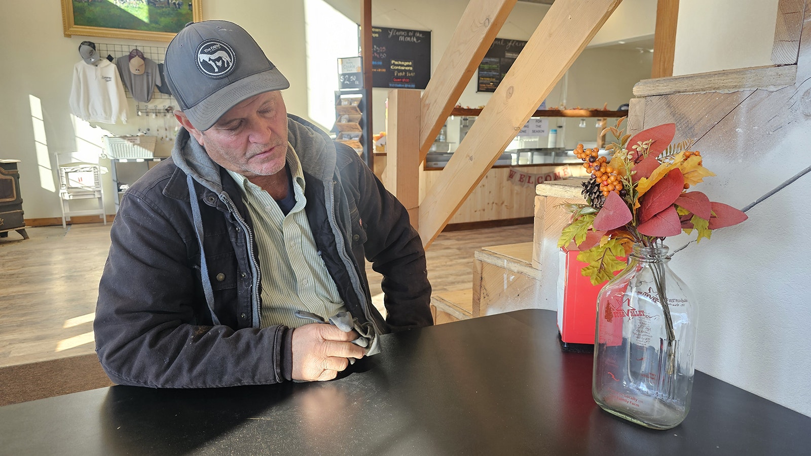 Jody Shumway looks at the date on a milk bottle from the three-year period when he was bottling pasteurized milk and selling it direct to consumer.