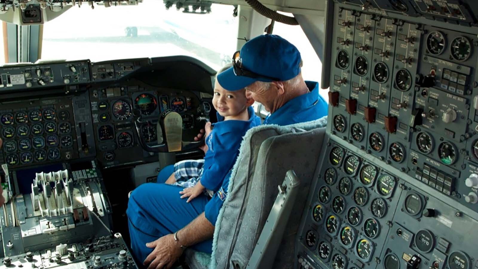 Larry LaRose with grandson Paco in the cockpit of a 747.