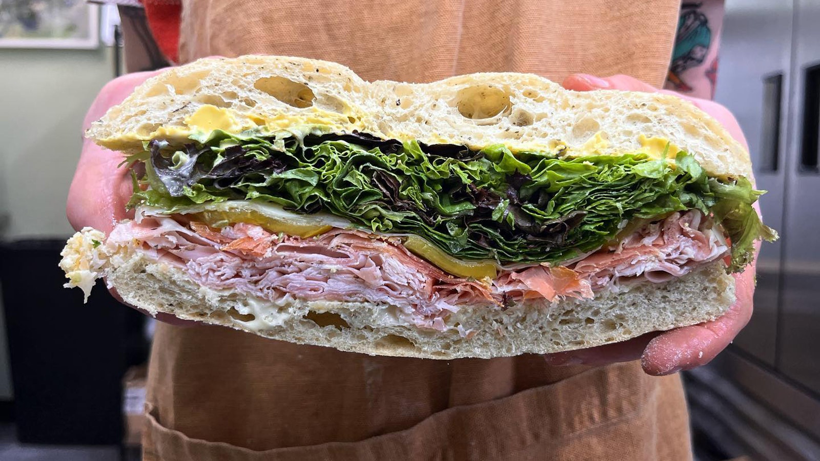 The Jamon sandwich with Jamon serrano ham, porchetta, greybull valley greens, asiago pressato, mustard and aioli.