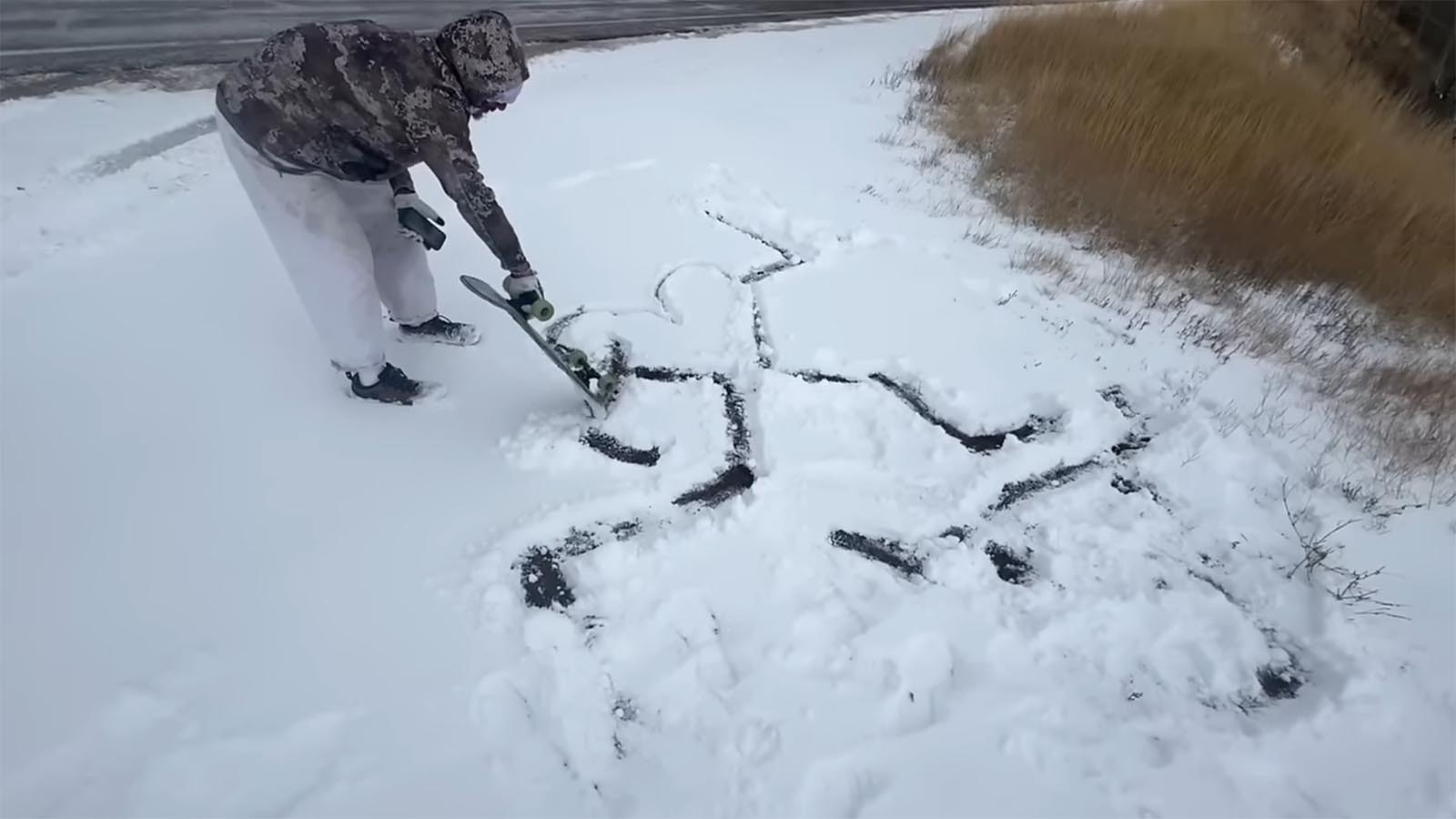 After reaching Cumbres Pass in Colorado at over 10,000 feet, Jason Vanporppal creates a snow outline of a skateboarder.