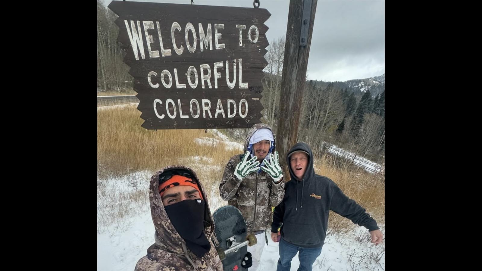 Jason Vanporppal, left, and Gregorio “Orio” Ramirez, center, pose for a photo after reaching the Colorado border.